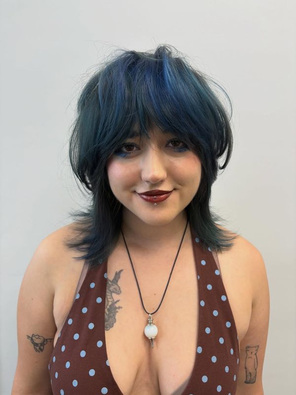 Shag cut with a blunt fringe on blue and black hair