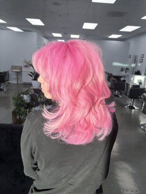 Full head of hot pink on a layered shag, back view