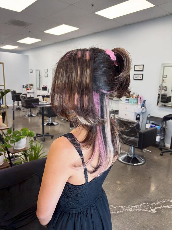 Pink and blonde peekaboo panels pulled into a ponytail