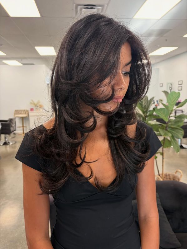 Face framing layers finished with a round brush blowout