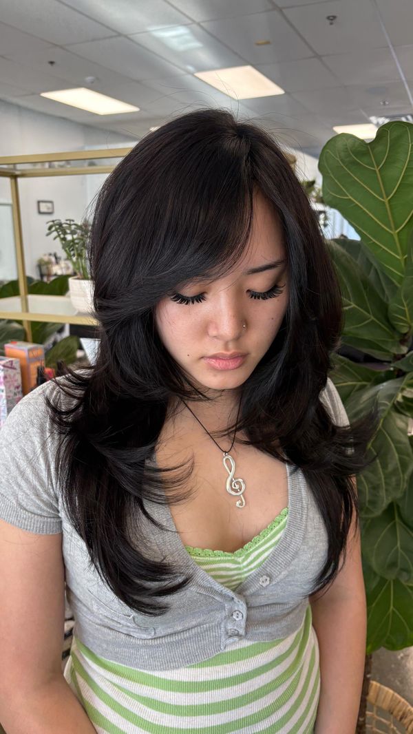 Side swept bangs and soft layers on dark hair