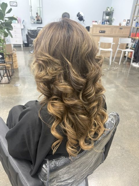 Blonde curls with extensions through the lengths, back view