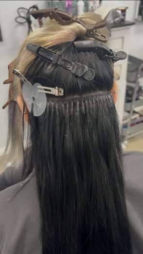 Rows of i-tip extensions beaded into blonde hair
